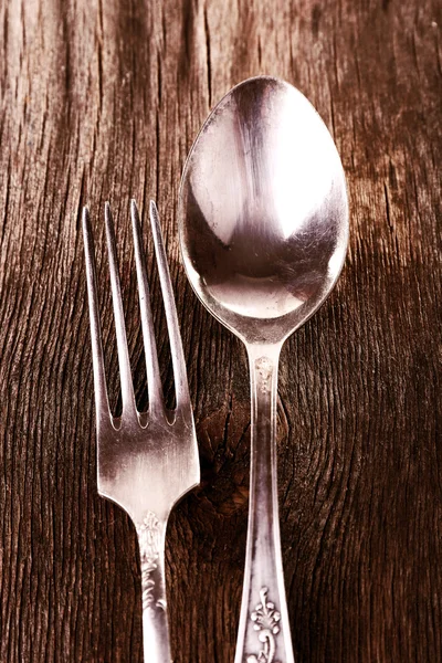 Old metal spoon and fork on wooden background — Stock Photo, Image