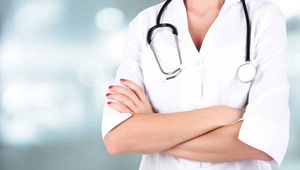Doctor with stethoscope on hospital background — Stock Photo, Image