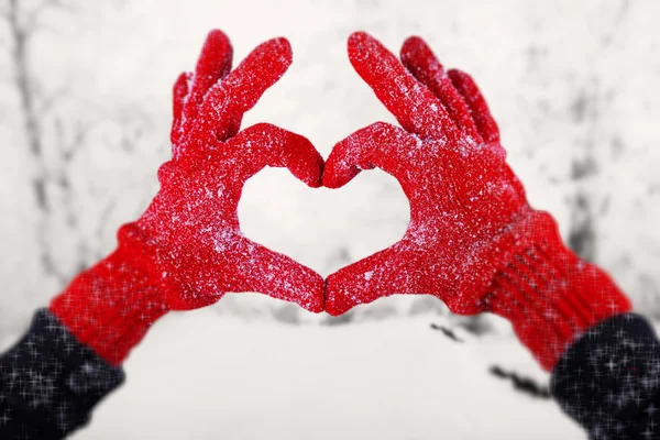 Las manos de mujer en guantes rojos sobre fondo natural de invierno — Foto de Stock