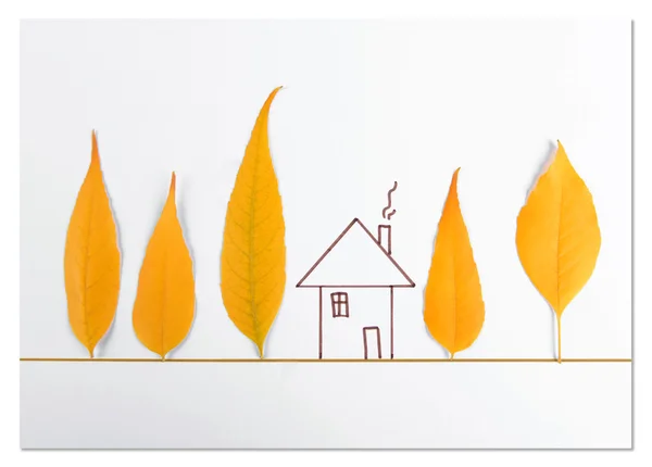 Autumn leaves with painted house on white paper — Stock Photo, Image