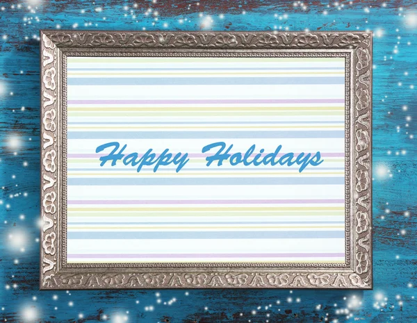 Christmas greeting card with frame on wooden background — Stock Photo, Image