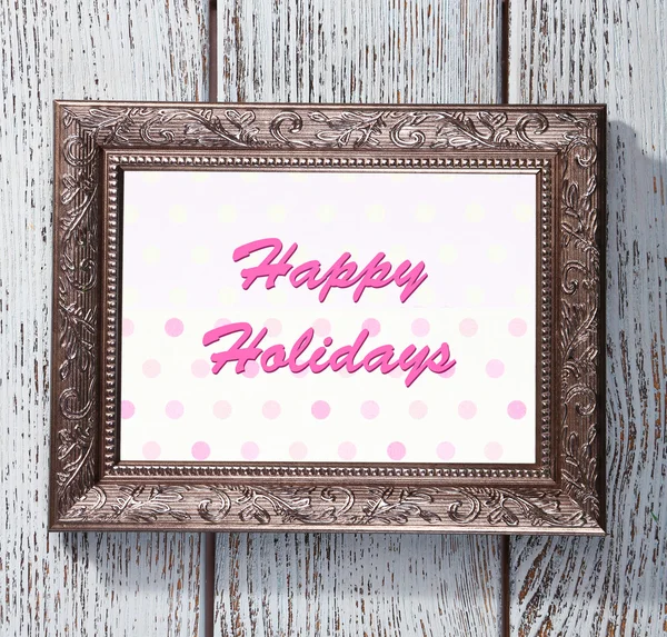 Christmas greeting card with frame on wooden background — Stock Photo, Image