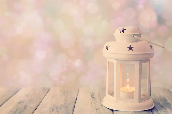 Lantern on wooden table on bright background — Stock Photo, Image