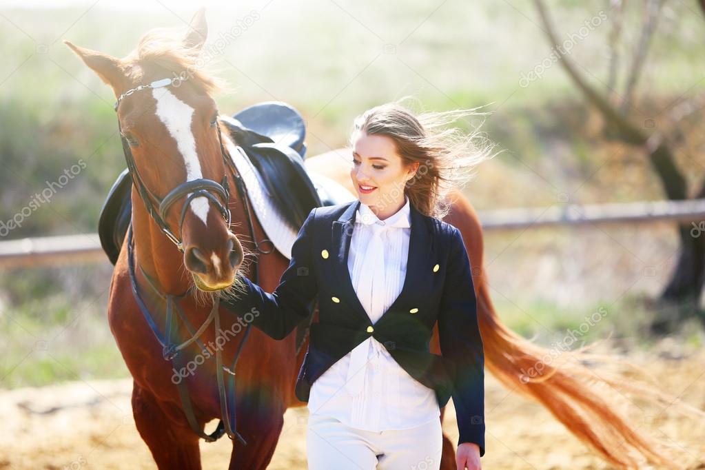 Beautiful girl with horse outdoors