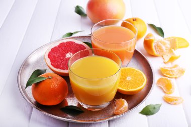 Greyfurt ve ahşap masa üzerinde mandalina suları