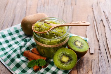 Delicious kiwi jam on table close-up clipart