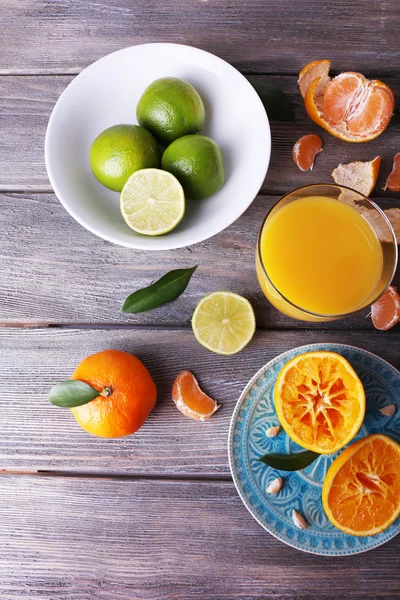 Suco e citrinos na mesa — Fotografia de Stock