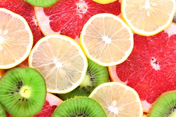 Ripe slices lemon, kiwi and grapefruit close-up background — Stock Photo, Image