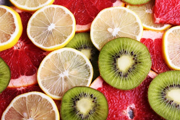 Стиглі скибочки лимона, ківі і грейпфрута крупним планом фон — стокове фото