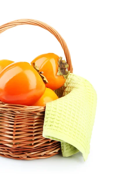 Ripe persimmons in wicker basket isolated on white — Stock Photo, Image