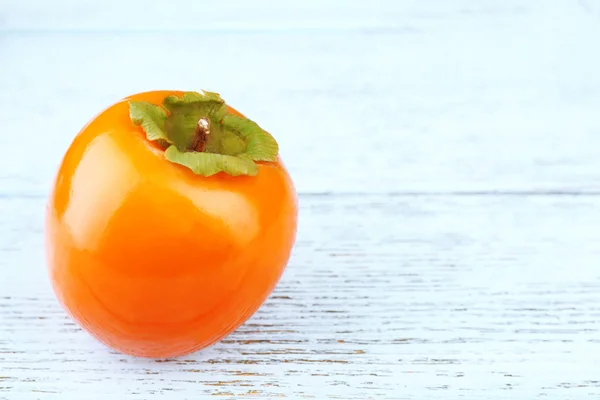 Ripe persimmon on wooden background — Stock Photo, Image