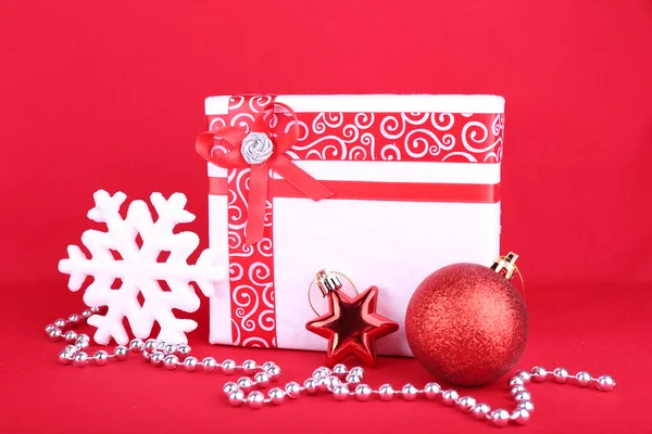 Güzel parlak hediye ve kırmızı bir arka plan üzerinde Noel dekorasyon — Stok fotoğraf