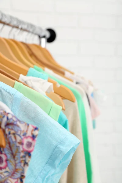 Different clothes on hangers close up — Stock Photo, Image