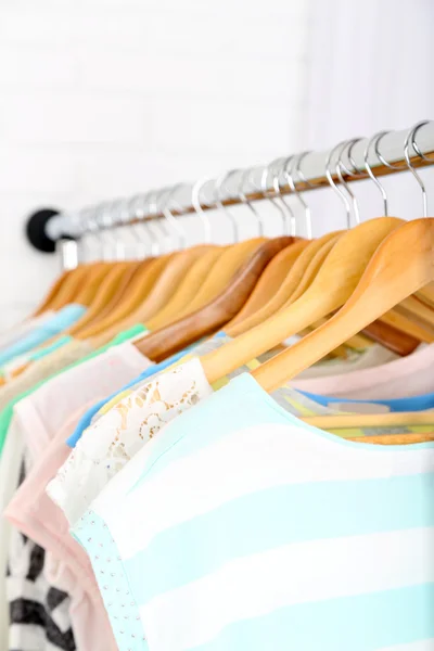 Different clothes on hangers close up — Stock Photo, Image