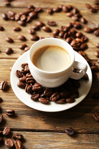 Cup of coffee on wooden table — Stock Photo, Image