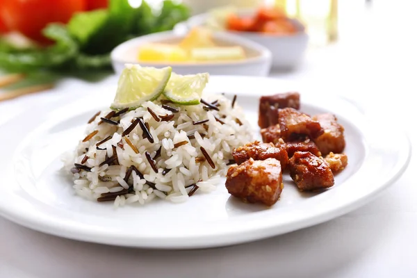 Tasty rice with meat served on table, close-up — Stock Photo, Image