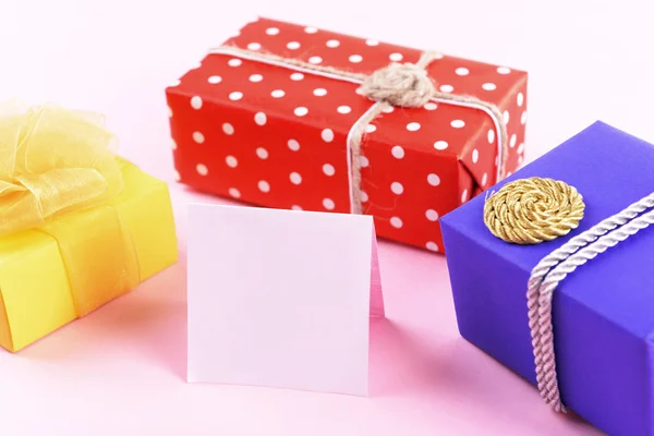 Colorful boxes with greeting card — Stock Photo, Image
