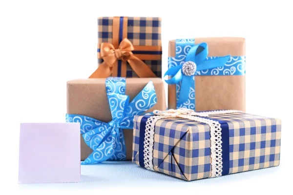 Gift boxes with greeting card on light blue uneven background — Stock Photo, Image