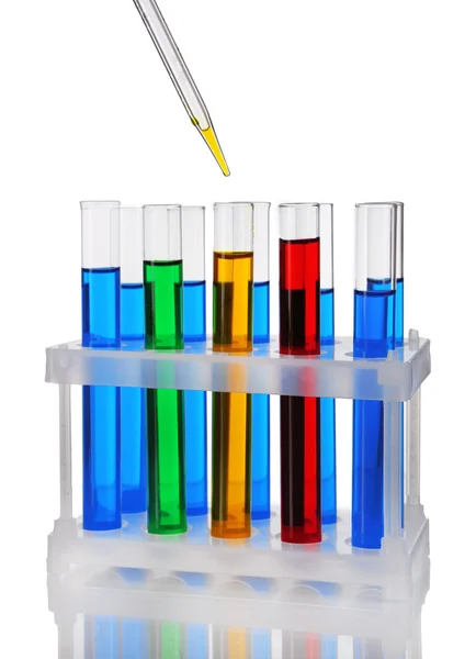 Pipette with drop of color liquid over container tubes isolated on white — Stock Photo, Image