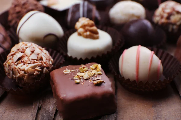 Many chocolates on wood — Stock Photo, Image
