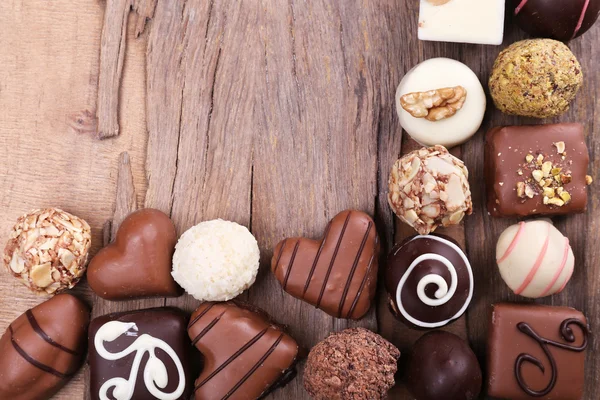 Group of sweets on wooden textured background — Stock Photo, Image