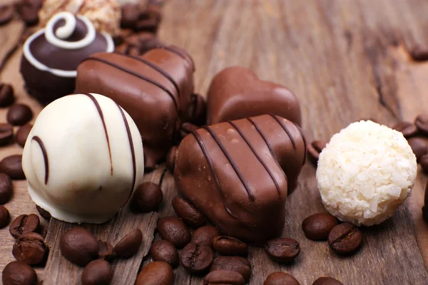 Chocolates diferentes con granos de café —  Fotos de Stock