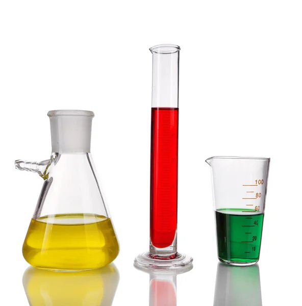 Test-tube and flasks with colorful fluid on light background — Stock Photo, Image