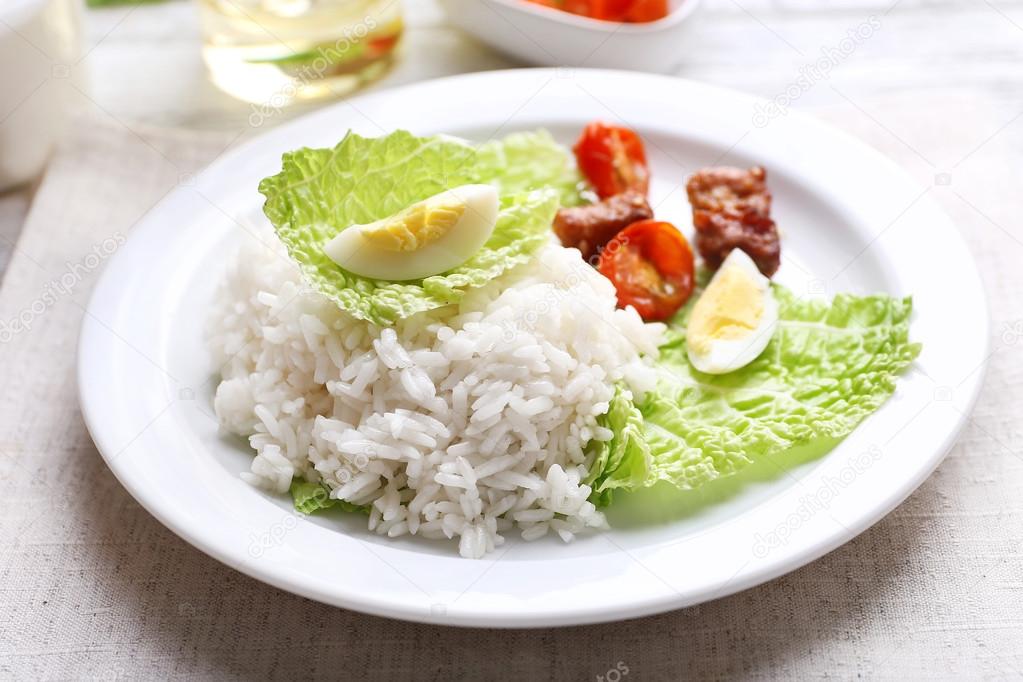 Boiled rice served on table, close-up