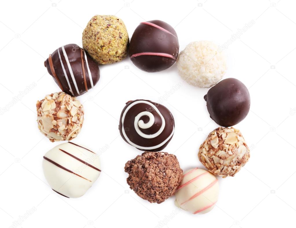 Spiral of chocolate sweet candies isolated on white background