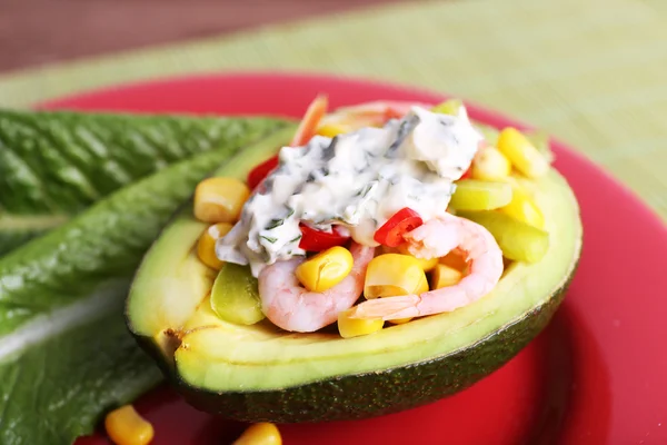 Tasty salad in avocado on plate table close-up — Stock Photo, Image