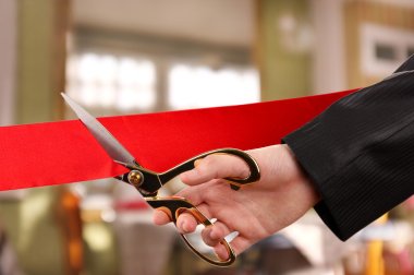 Grand opening, hand cutting red ribbon