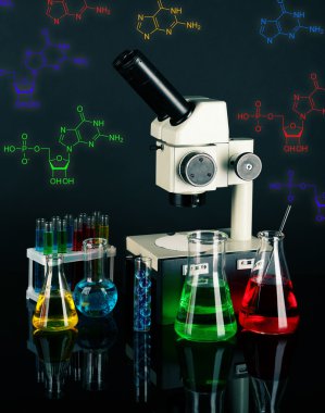 Test tubes with colorful liquids and microscope on dark background clipart