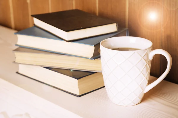 Old books and cup of coffee — Stock Photo, Image
