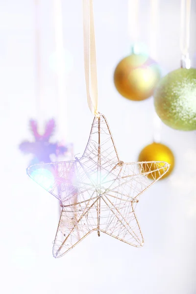 Christmas decorations hanging on festive background — Stock Photo, Image
