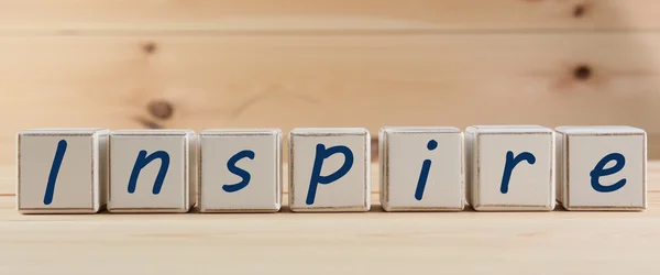 INSPIRE spelled in wooden blocks — Stock Photo, Image