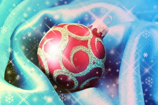 Beautiful Christmas ball on satin cloth, close-up — Stock Photo, Image