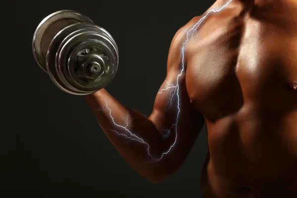 Muscle young man on black background — Stock Photo, Image