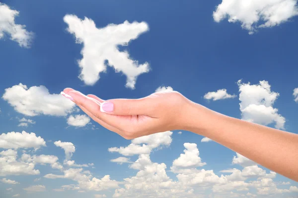 Airplane clouds shape floating on hand — Stock Photo, Image