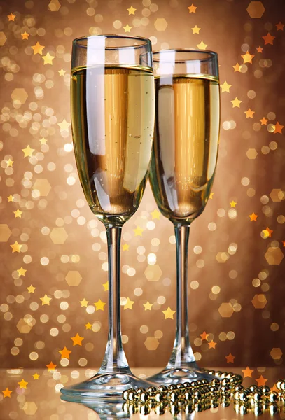 Glasses of champagne on bright background — Stock Photo, Image