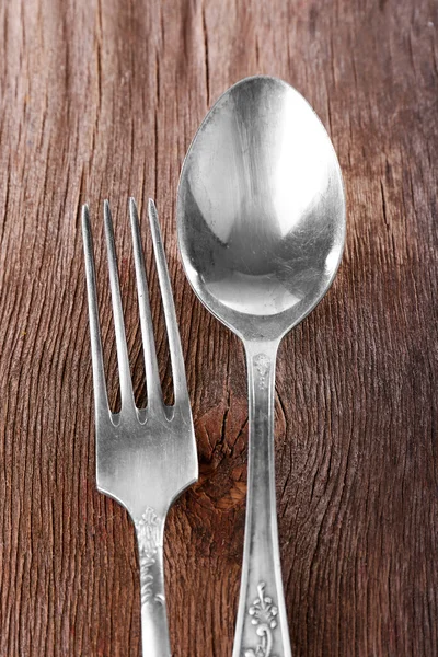 Spoon and fork on wooden background — Stock Photo, Image