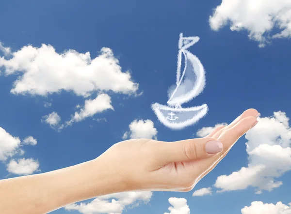 Sailboat clouds shape floating on hand — Stock Photo, Image