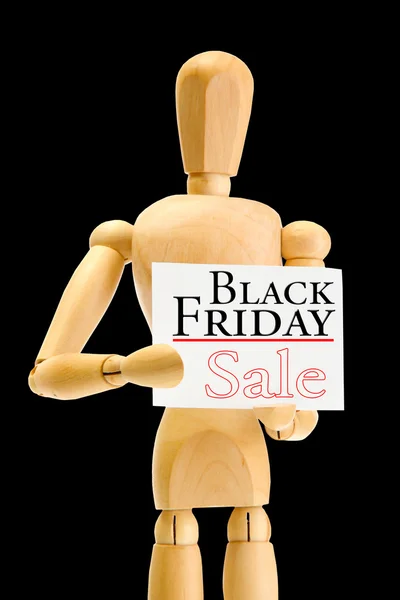 Wooden mannequin with Black Friday Sale advertising isolated on black — Stock Photo, Image