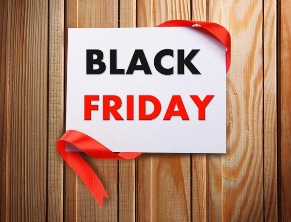 Card with Black Friday text on wooden background — Stock Photo, Image