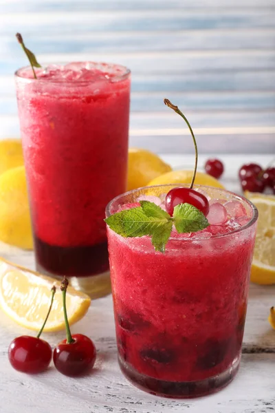 Fresh cold cherry cocktail with mint, ice and lemon — Stock Photo, Image