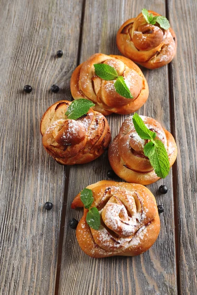 Tasty buns with berries on table close-up — Stock Photo, Image