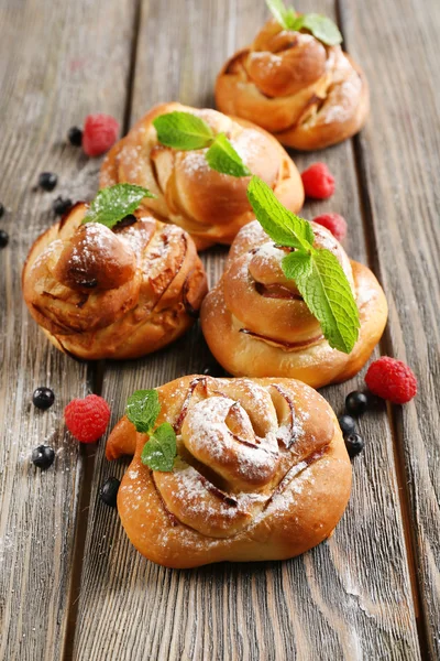 Tasty buns with berries on table close-up — Stock Photo, Image