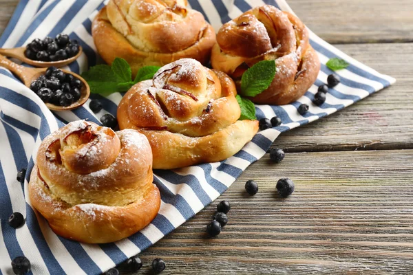 Tasty buns with berries on table close-up — Stock Photo, Image