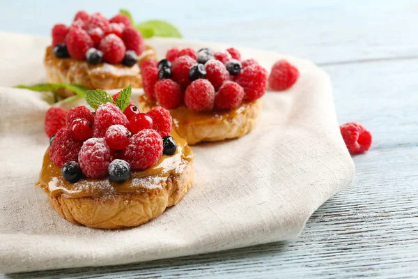 Süße Kuchen mit Beeren auf dem Tisch in Großaufnahme — Stockfoto