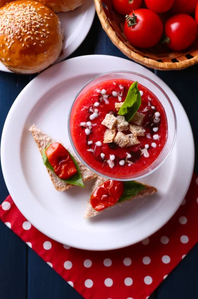 Gazpacho soup in glass bowl, on color wooden background — Stockfoto