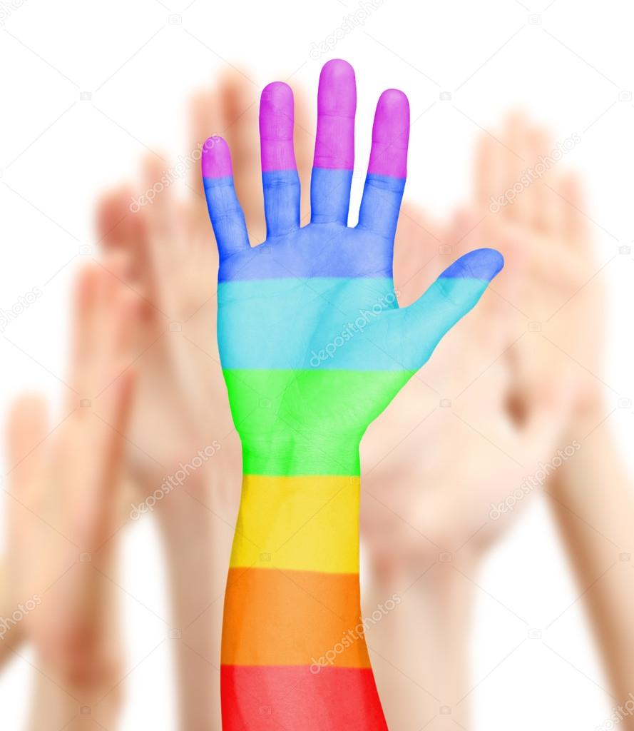 Man's hand painted as the rainbow flag on other hands background